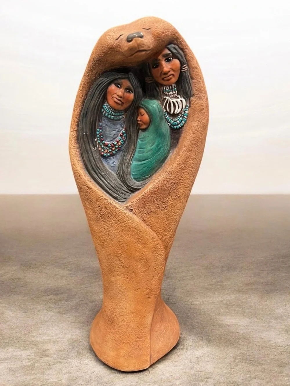 hand-painted ceramic bisque Native American family figurine sculpture.